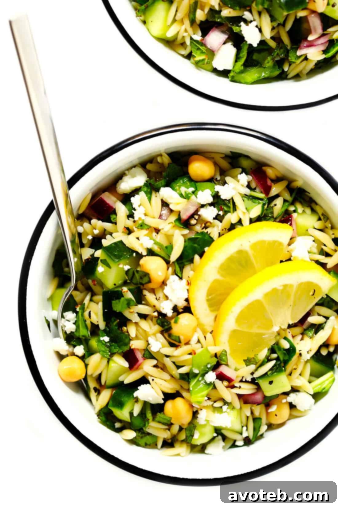Lemony Orzo Pasta Salad brimming with fresh herbs, spinach, chickpeas, cucumber, and feta cheese, perfect for a healthy and delicious meal.