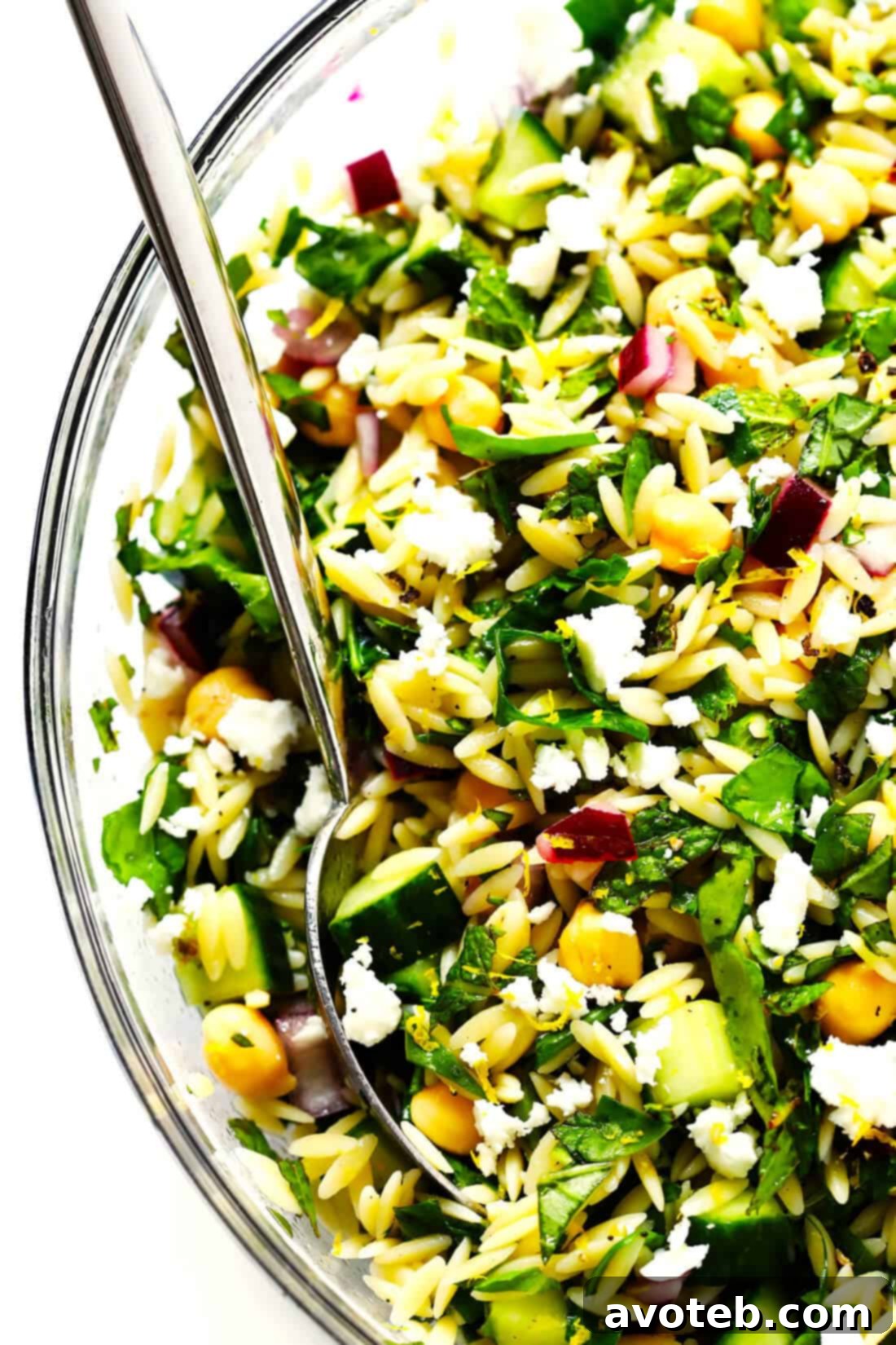 Serving of Lemony Orzo Salad with a fork, highlighting the fresh and healthy appeal.