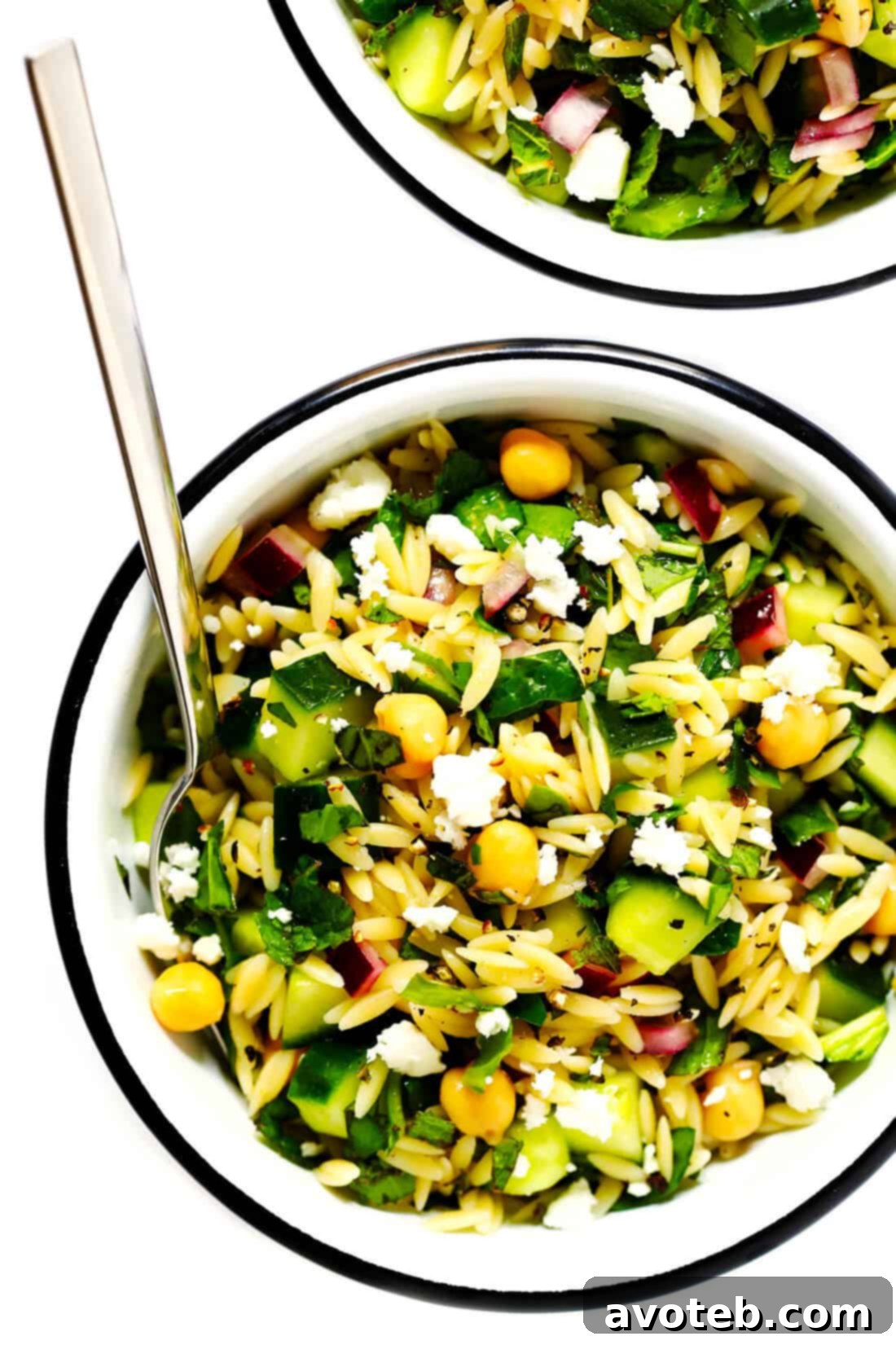 Delicious Lemony Orzo Chickpea Pasta Salad in a bowl, ready to be enjoyed as a refreshing and healthy vegetarian meal.