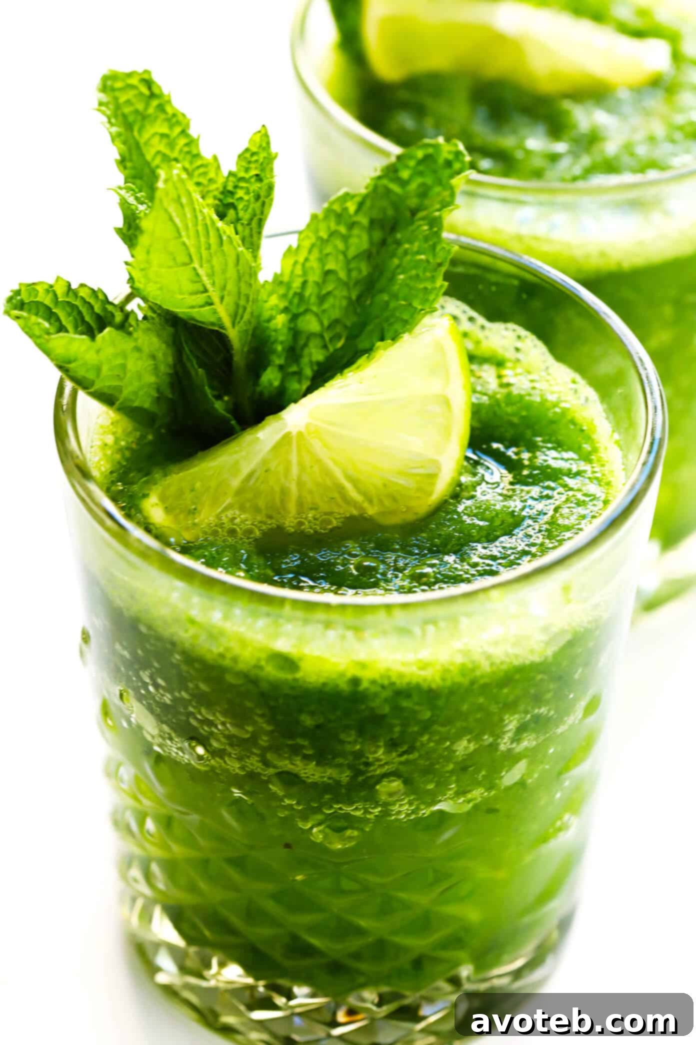 Three glasses of Frozen Mojitos, beautifully garnished with mint and lime, ready to be served.