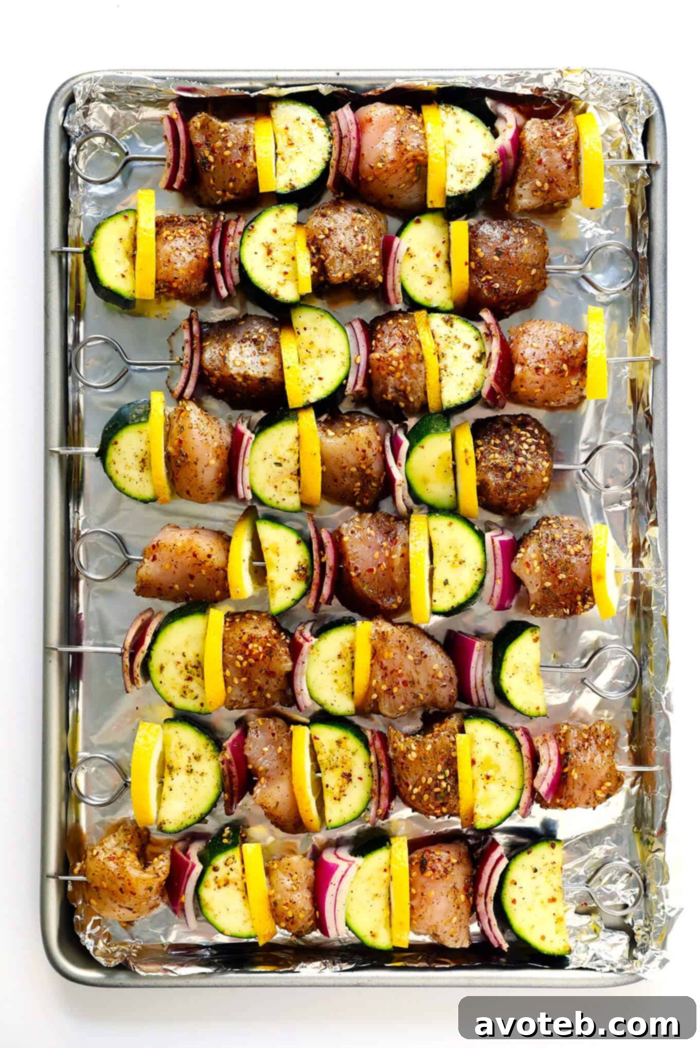 Cooked Za'atar Chicken and Veggie Kabobs resting on a baking sheet.