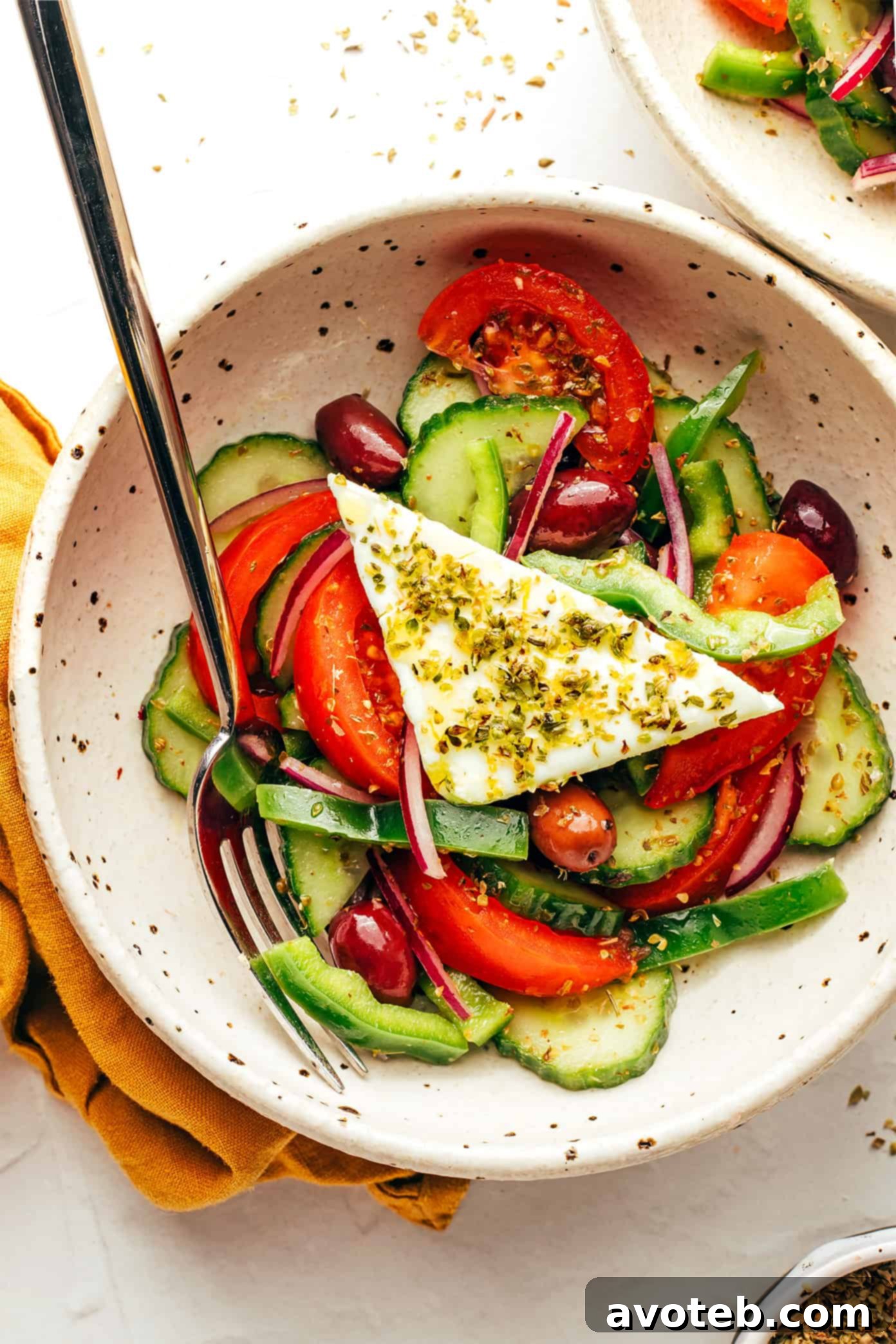 A beautifully arranged table with Greek salad and other dishes