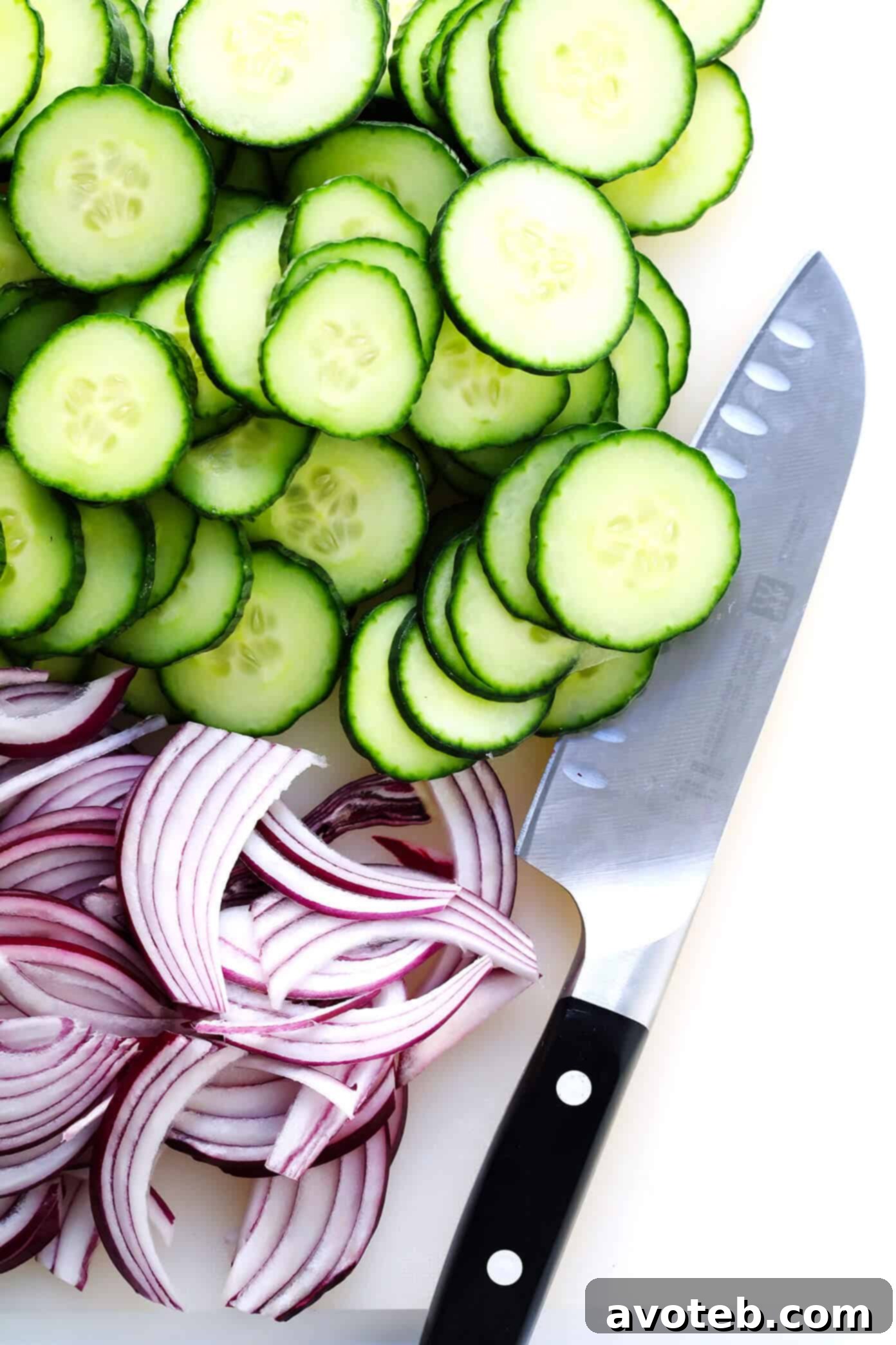 Slicing English cucumber and red onion to make a side salad for the Everyday Salad recipe.