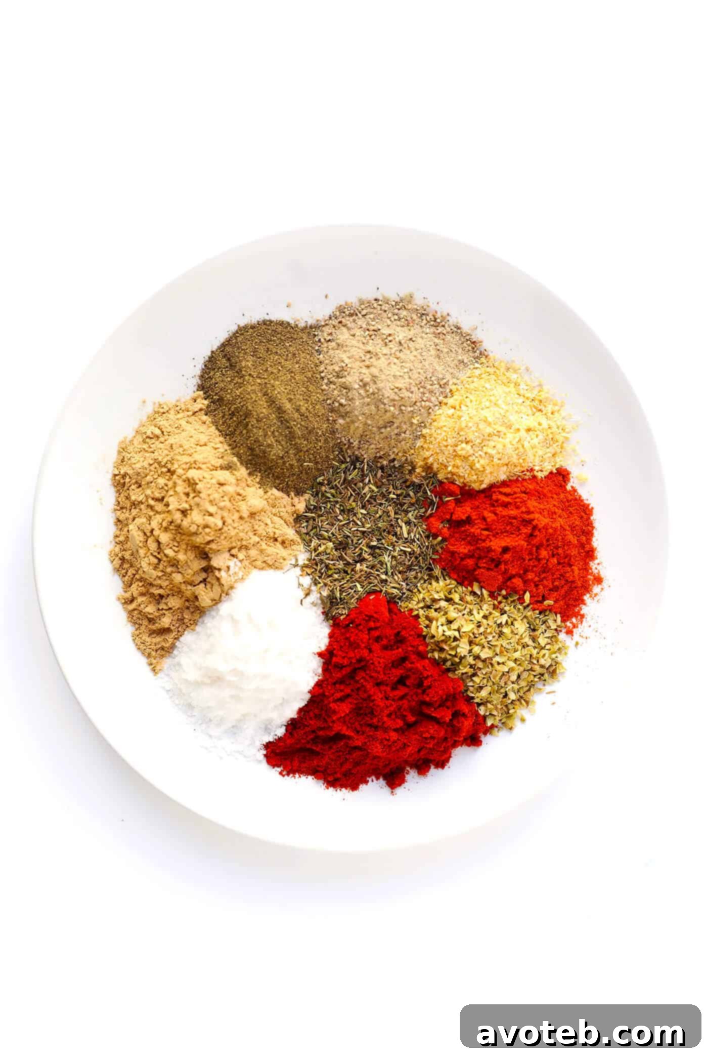 Hands are shown mixing various spices together in a bowl, demonstrating the simple process of making Cajun seasoning.