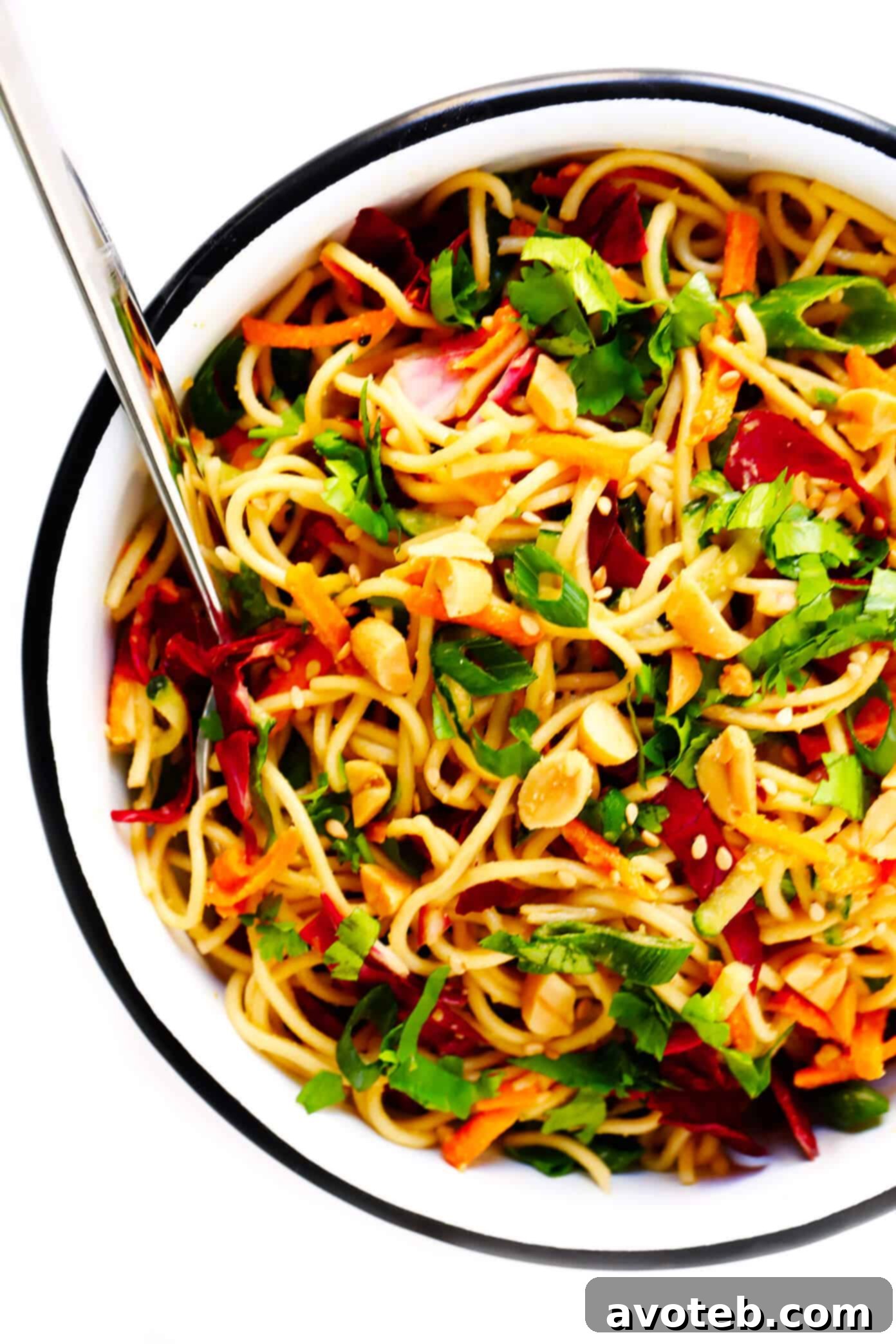 A bowl of delicious Cold Sesame Peanut Noodles garnished with fresh cilantro and lime