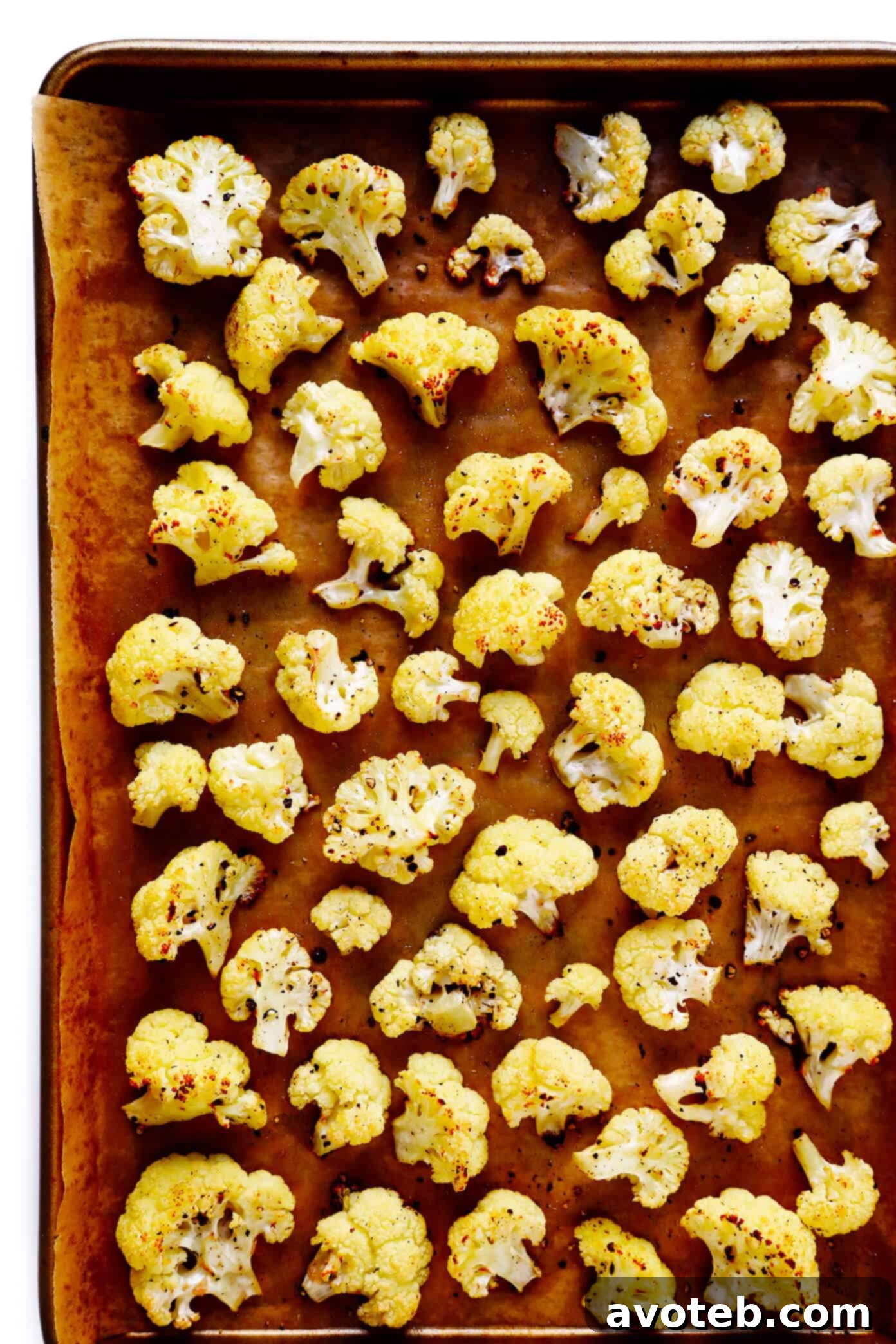 The BEST Roasted Cauliflower recipe -- super easy to make in the oven, naturally #glutenfree and #vegan, and easy to customize with any of your favorite seasonings. It's the perfect healthy side dish. Or perfect for adding to a salad, soup, pizza, dip, pasta, tacos or more! | Gimme Some Oven Roasted Cauliflower Recipe - Perfectly golden florets on a baking sheet