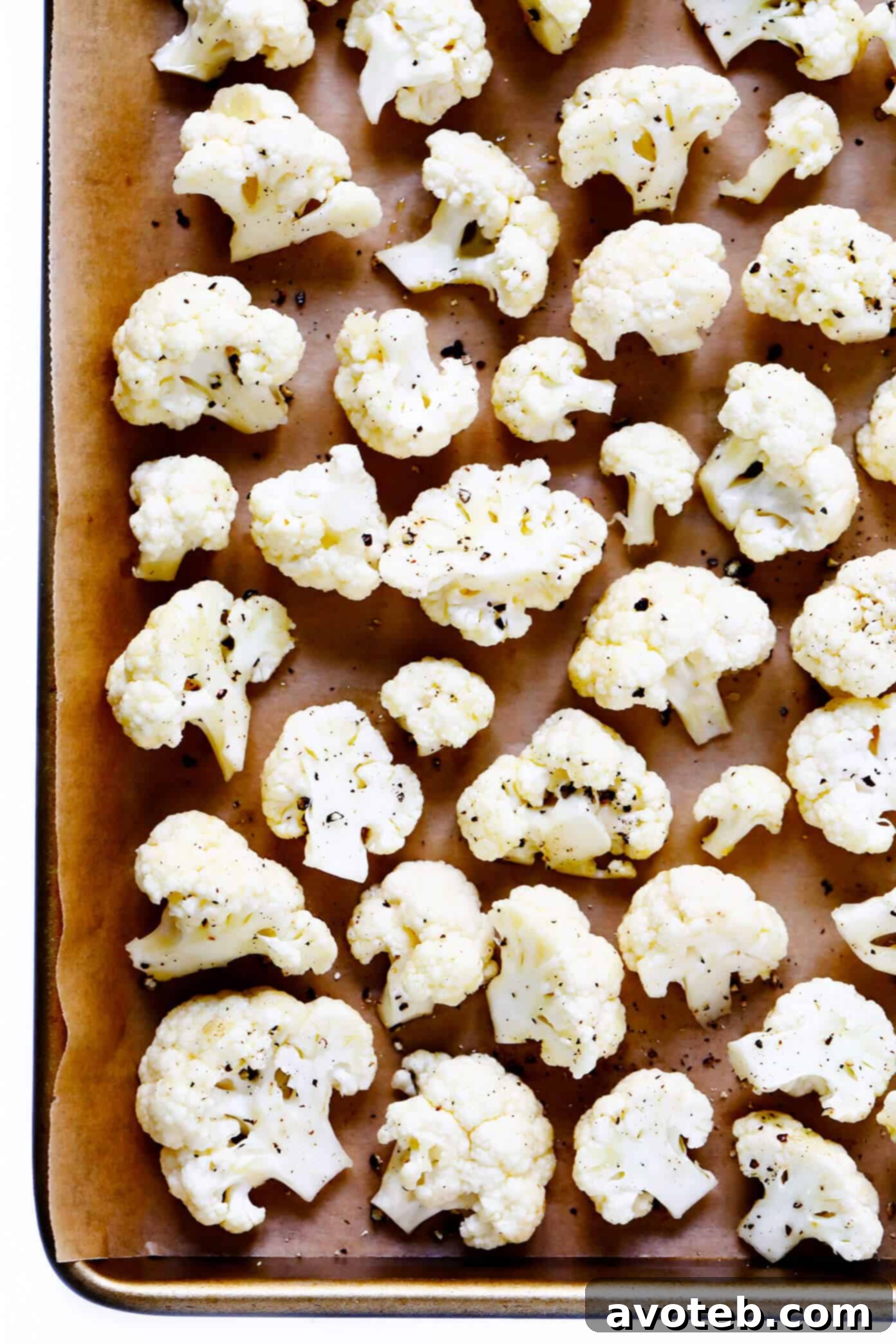 The BEST Roasted Cauliflower recipe -- super easy to make in the oven, naturally #glutenfree and #vegan, and easy to customize with any of your favorite seasonings. It's the perfect healthy side dish. Or perfect for adding to a salad, soup, pizza, dip, pasta, tacos or more! | Gimme Some Oven Raw Cauliflower florets ready for roasting