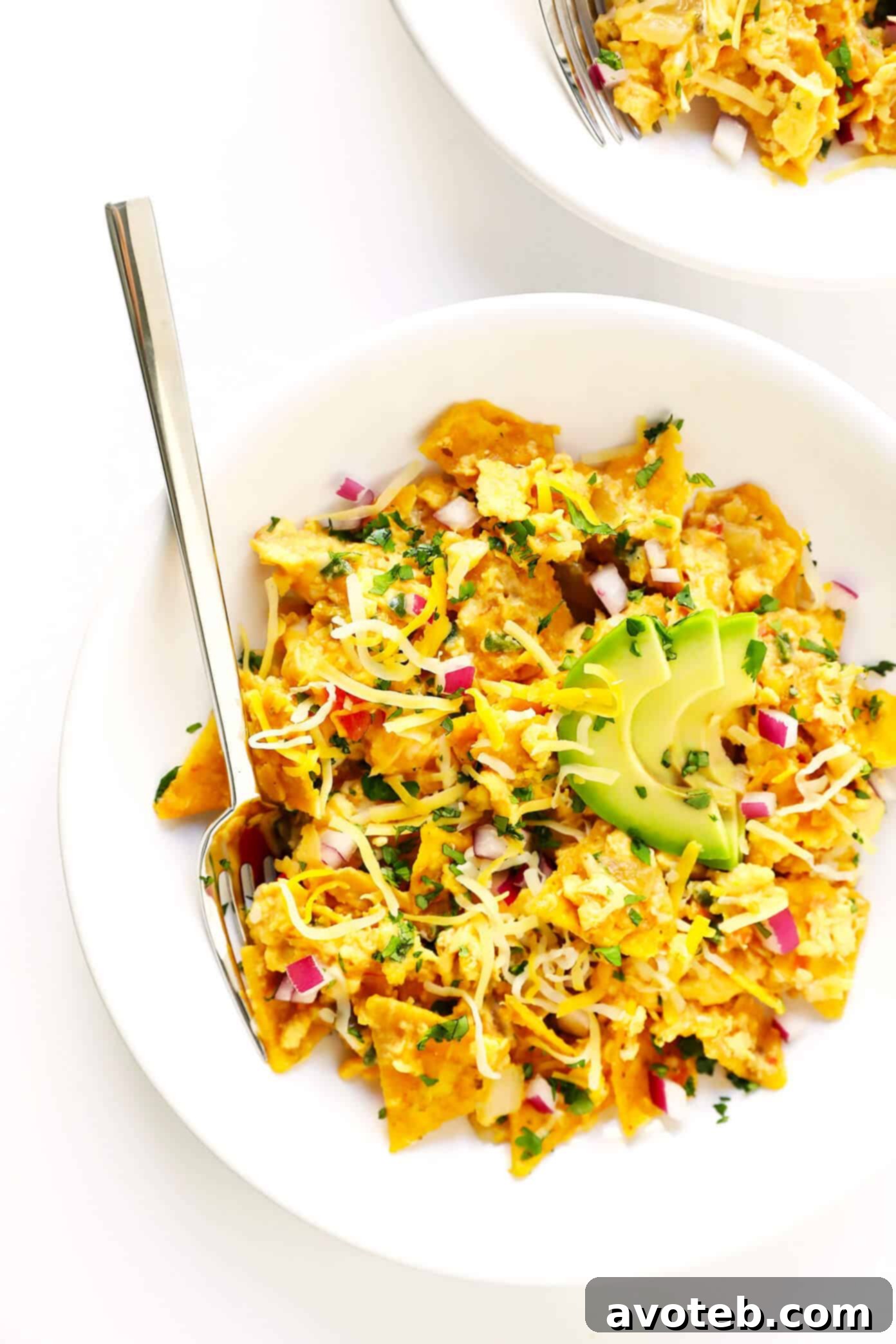 The Best (and Easiest!) Migas Recipe: An easy Tex-Mex egg scramble with leftover tortilla chips and salsa, topped with avocado and cheese. Perfect for a quick breakfast, brunch, lunch, or a unique vegetarian dinner.