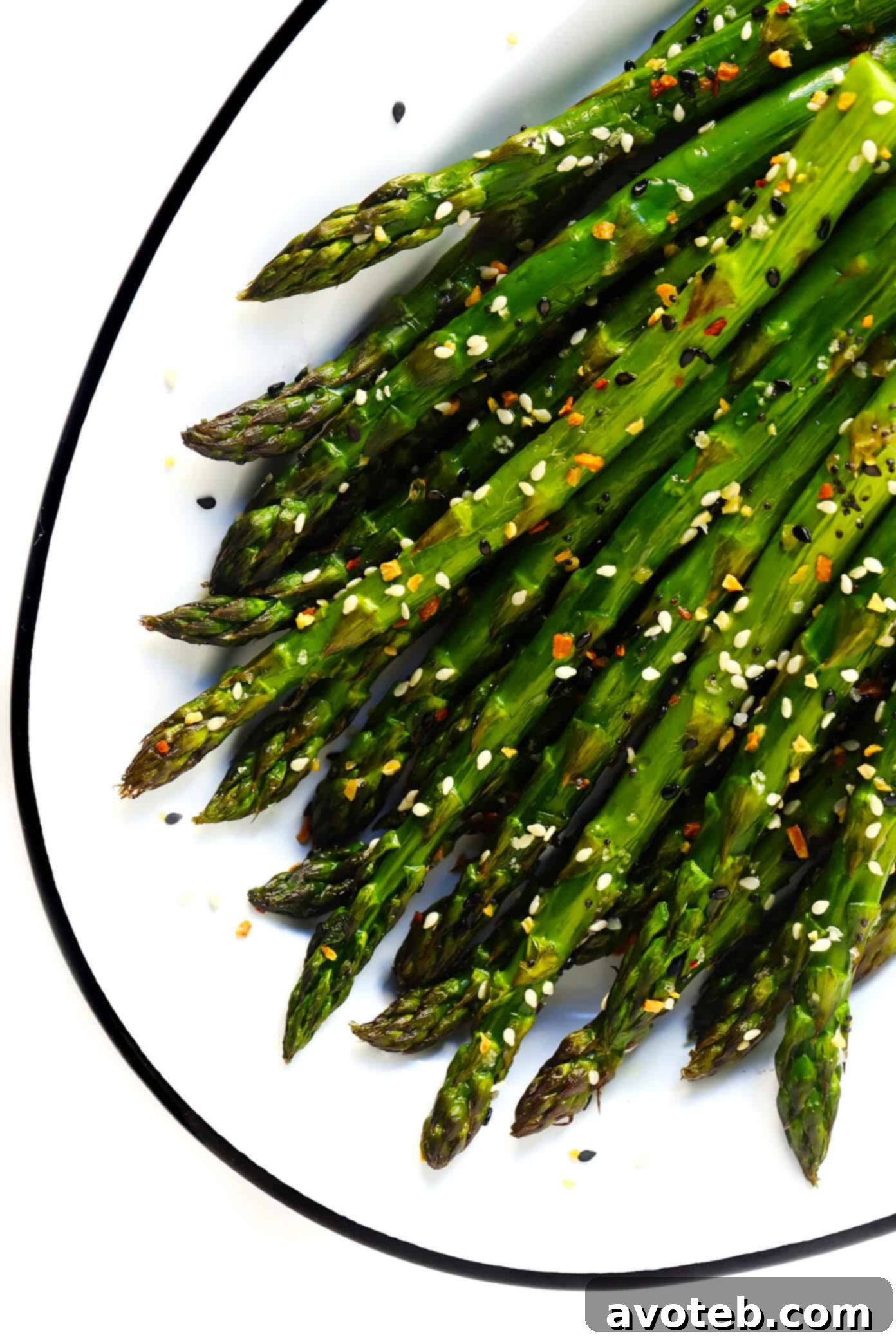 Kick your roasted asparagus recipe up a notch this season with some everything bagel seasoning! It's super quick and easy to make, naturally vegan and gluten-free, and makes the most delicious healthy side dish. | Gimme Some Oven #asparagus #side #vegetable #healthy #dinner #thanksgiving #christmas #holiday #fall #winter "Everything" Roasted Asparagus with Sea Salt - garnished and ready to serve.