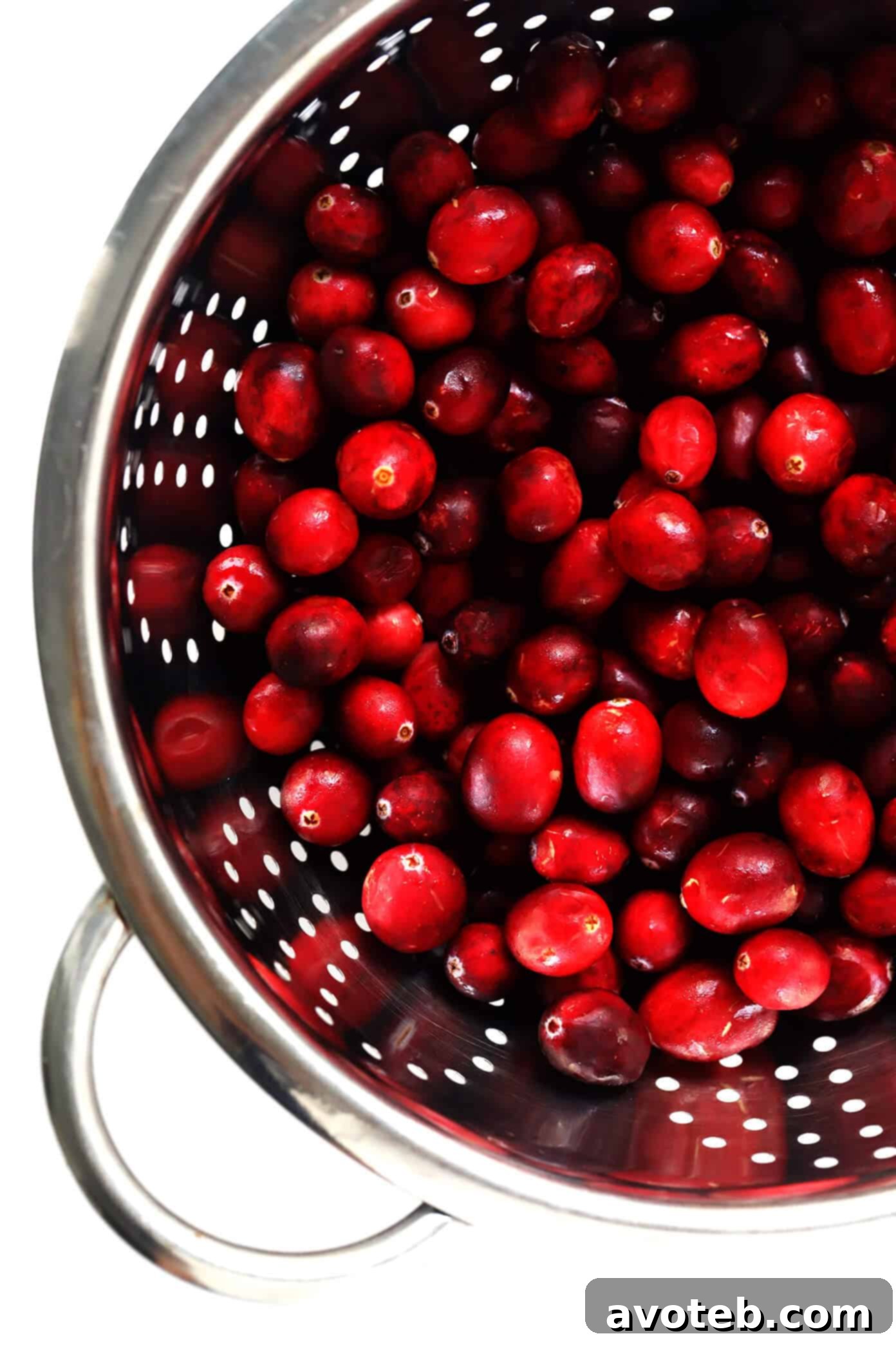Fresh Cranberries being rinsed in a strainer
