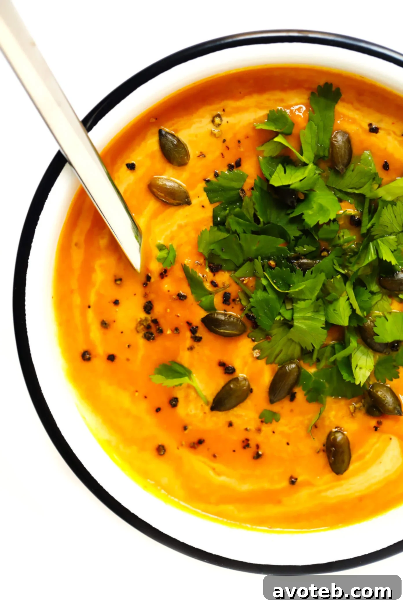 Ingredients for Thai Curried Pumpkin Soup laid out, including canned pumpkin puree, coconut milk, curry paste, and fresh cilantro.