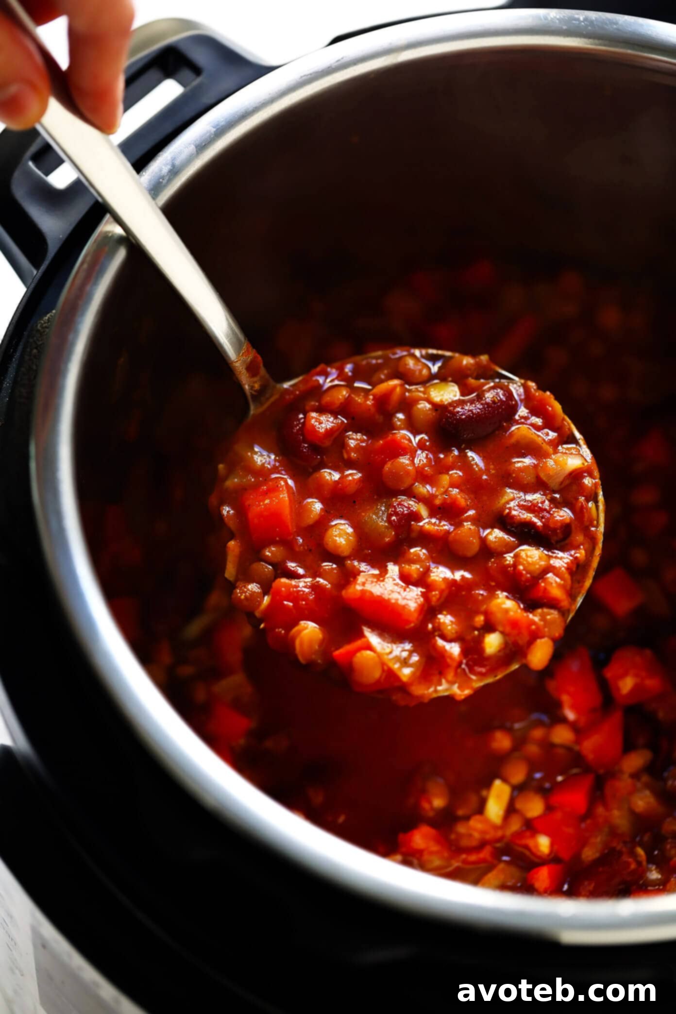 Easy and fast preparation of vegetarian chili in an Instant Pot, featuring colorful vegetables and rich spices, showing the initial sautéing step.