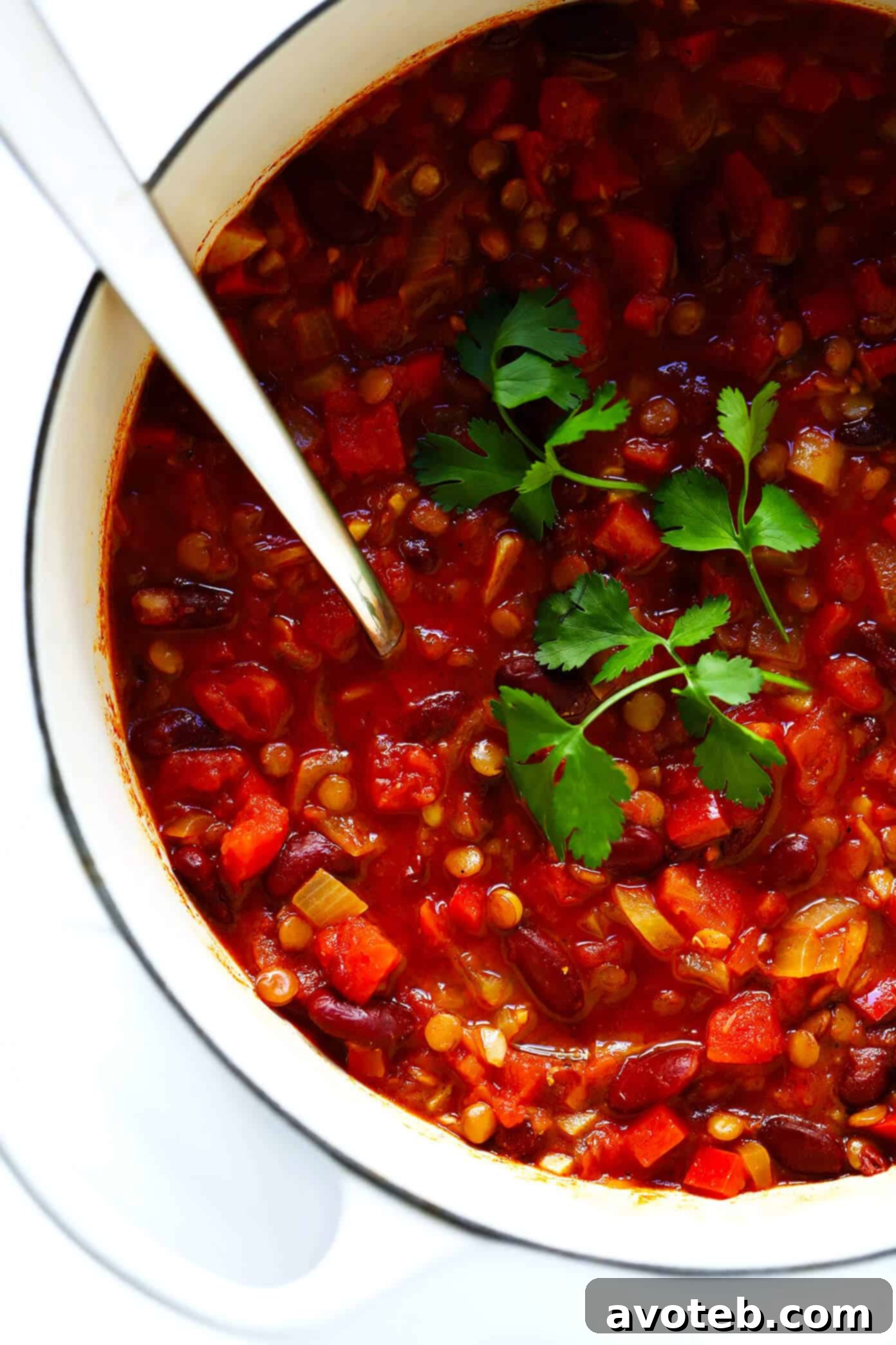 A vibrant pot of the best vegetarian chili, simmering on the stovetop, showcasing its rich texture and colorful blend of vegetables and beans.