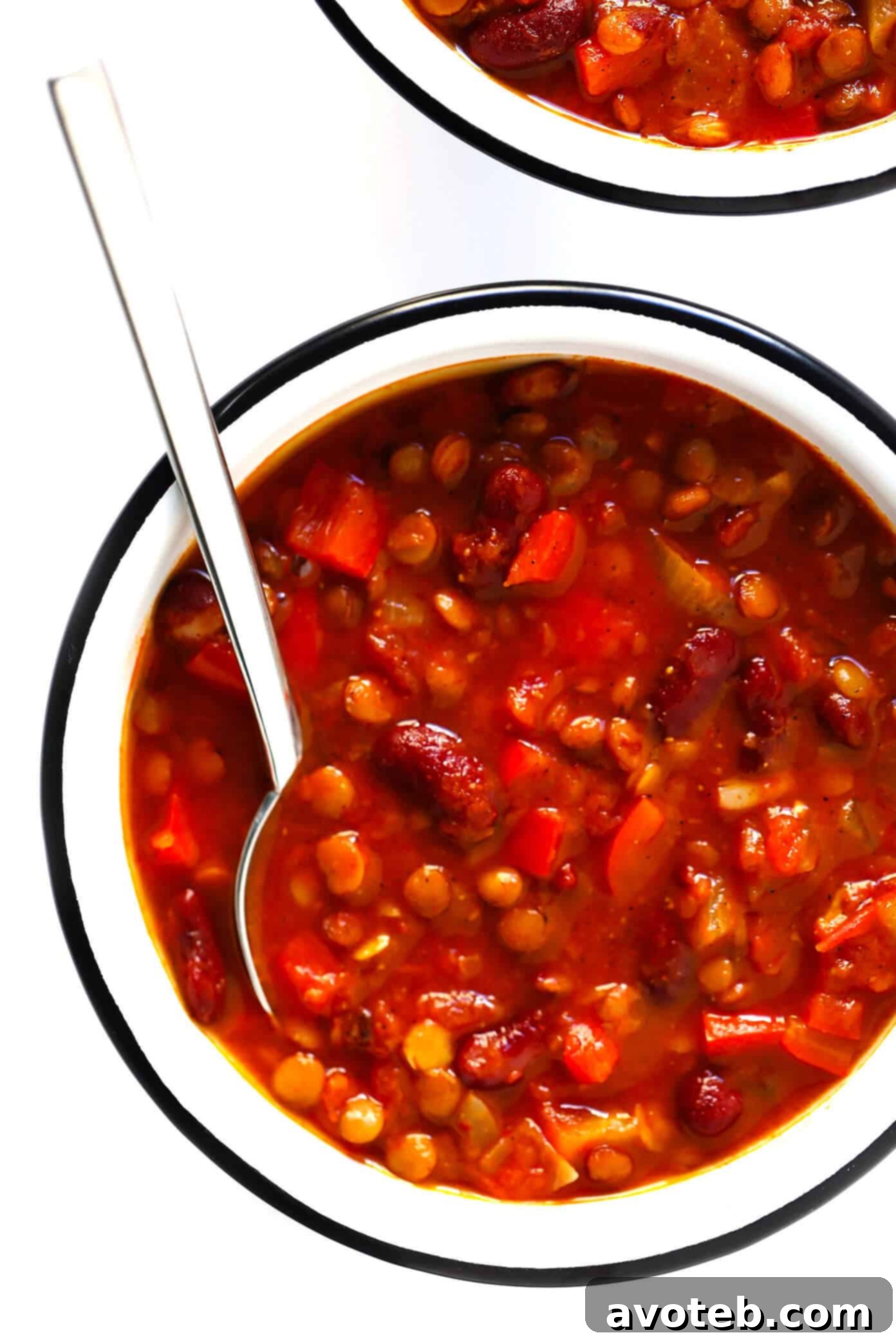 A bowl of easy vegetarian chili, artfully garnished with fresh herbs and a swirl of sour cream, ready for serving.