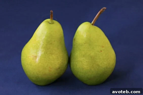 Close-up of roasted pears in a baking dish, ready to be served in the salad.