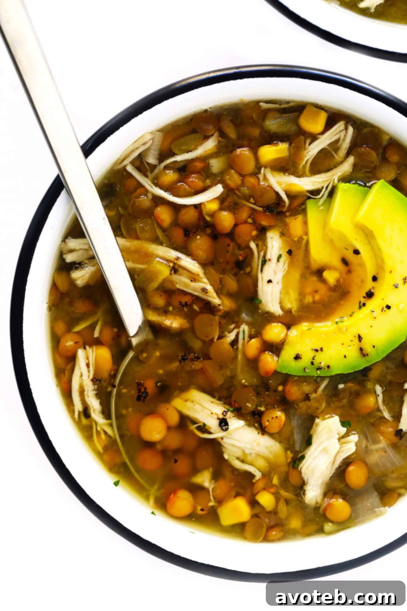 Hearty Mexican Chicken Lentil Soup with vibrant toppings, perfect for meal prep.