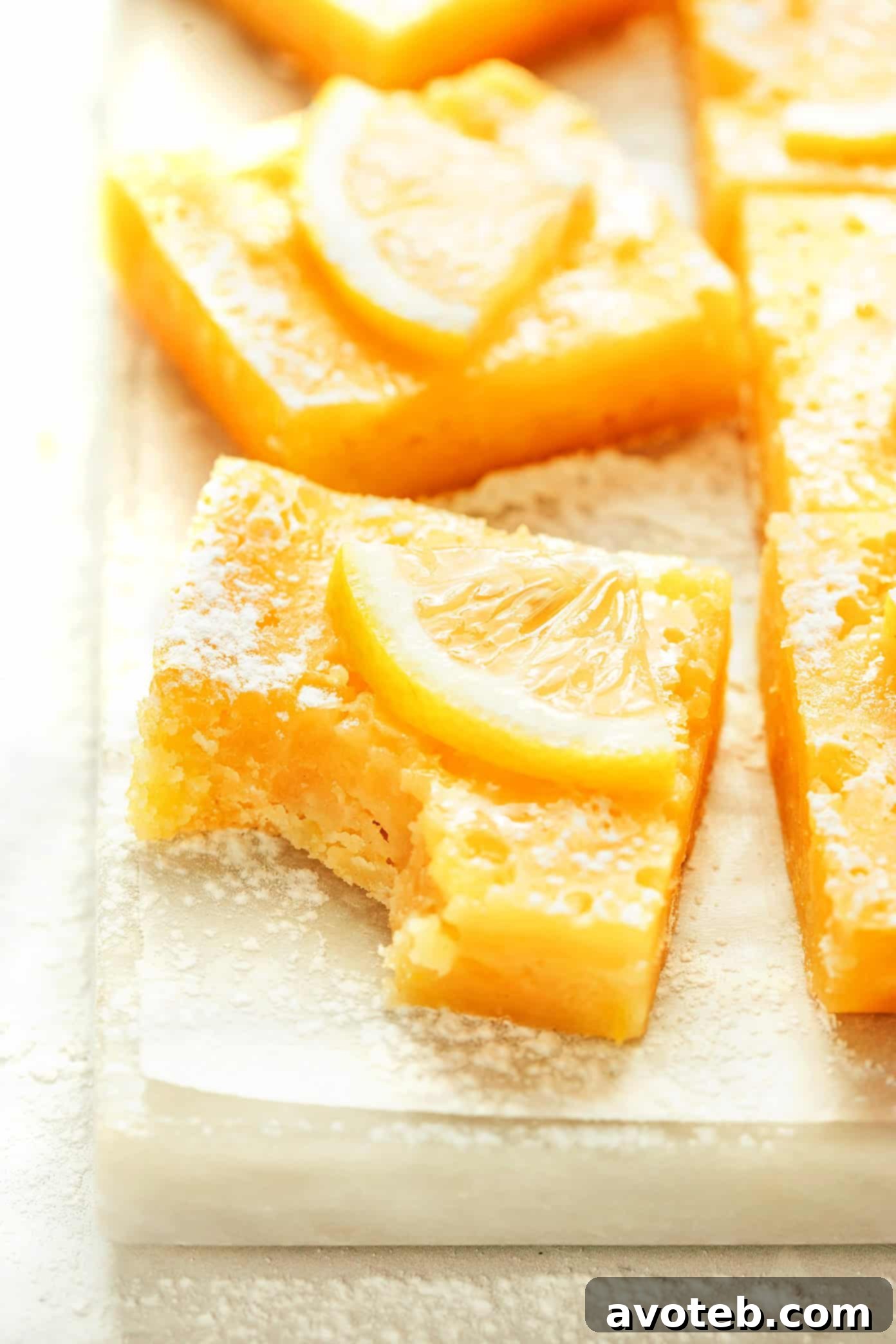 Simply Zesty Lemon Bars 5 A slice of lemon bar on a white plate