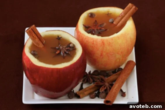 Freshly made apple cider cups with cinnamon sticks, ready to be enjoyed. A perfect, natural vessel for your favorite fall beverage.