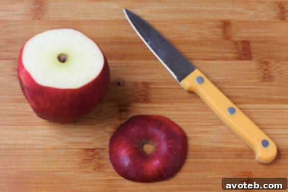 A close-up view of hollowed-out apples prepared to hold apple cider, showcasing the natural beauty of the fruit.