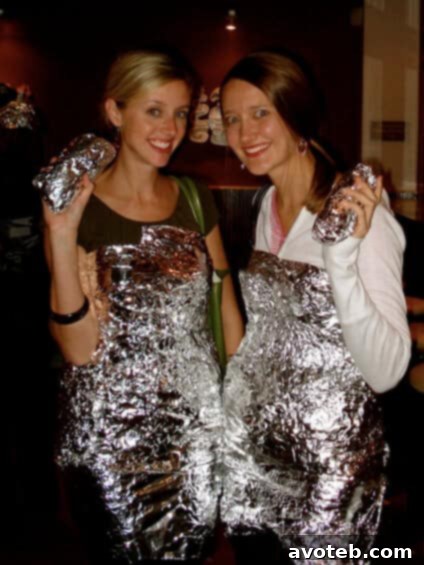 Throwback: Classic Boo-rito Halloween Costume at Chipotle A person in a traditional 'boo-rito' costume, wrapped like a giant burrito, holding a Chipotle burrito, from a previous Halloween event.