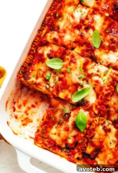 The best homemade lasagna in a pan with a single slice removed, showing all the cheesy, meaty layers.