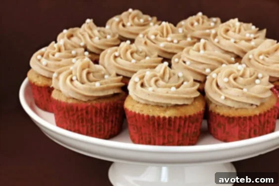 Delicious Vanilla Chai Cupcakes with creamy cinnamon buttercream frosting, artfully arranged on a cooling rack.