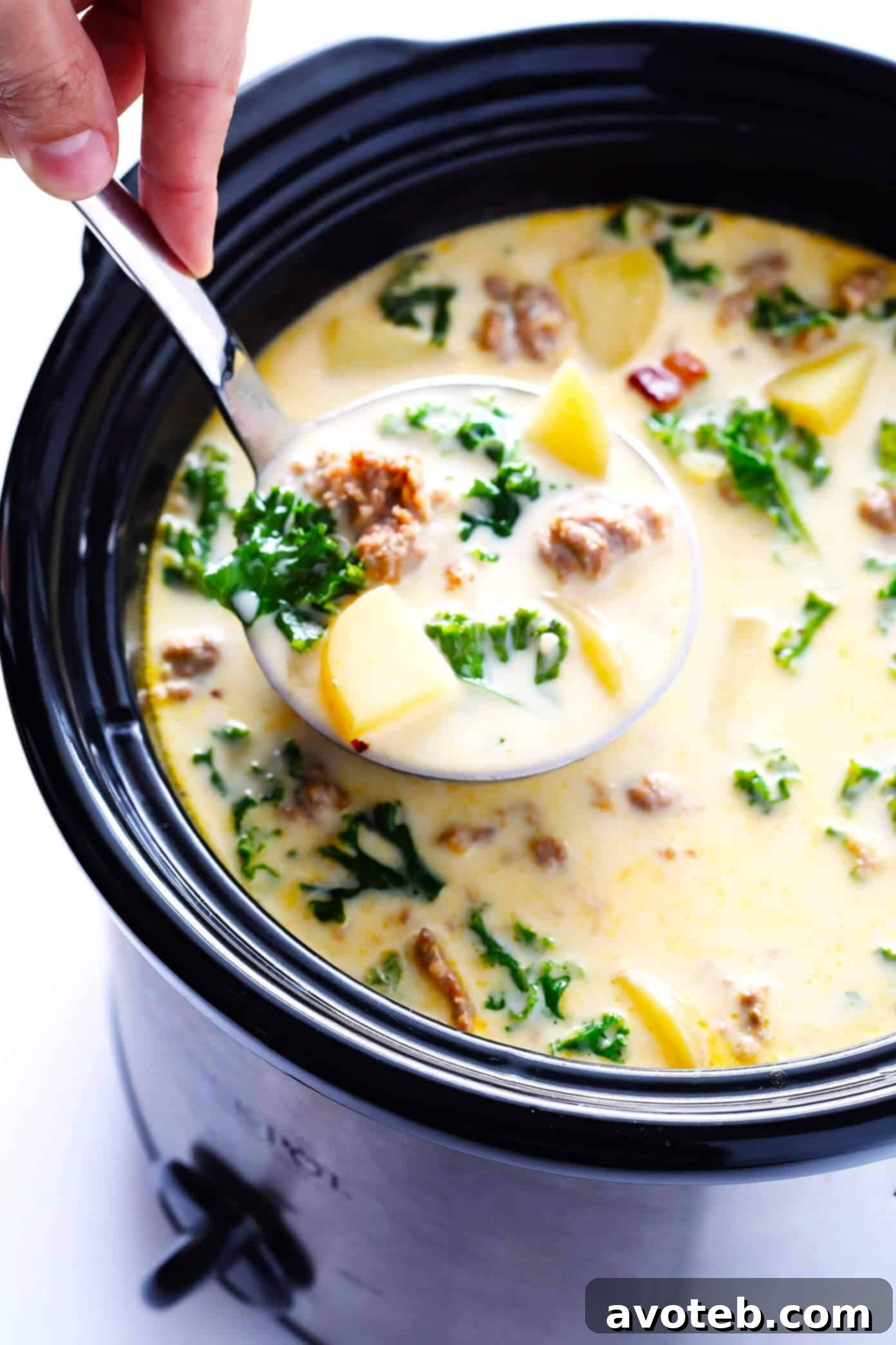 A vibrant overhead shot of all the fresh ingredients laid out for Zuppa Toscana: spicy Italian sausage, fresh green kale, golden Yukon Gold potatoes, aromatic garlic cloves, a white onion, thick-cut bacon, and a bottle of rich heavy cream, ready for preparation.