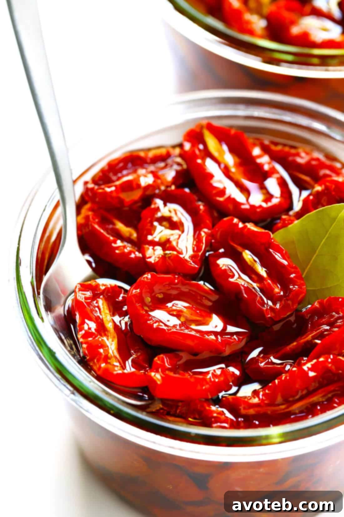 Learn how to make sun-dried tomatoes in the oven! This recipe can be easily customized to be as spicy, garlicky, herby or plain as you prefer. | gimmesomeoven.com #sundriedtomatoes #tomatoes #summer #topping #italian #healthy #vegan #glutenfree Oven Sun-Dried Tomatoes: A vibrant spread of sliced tomatoes seasoned and ready for roasting.