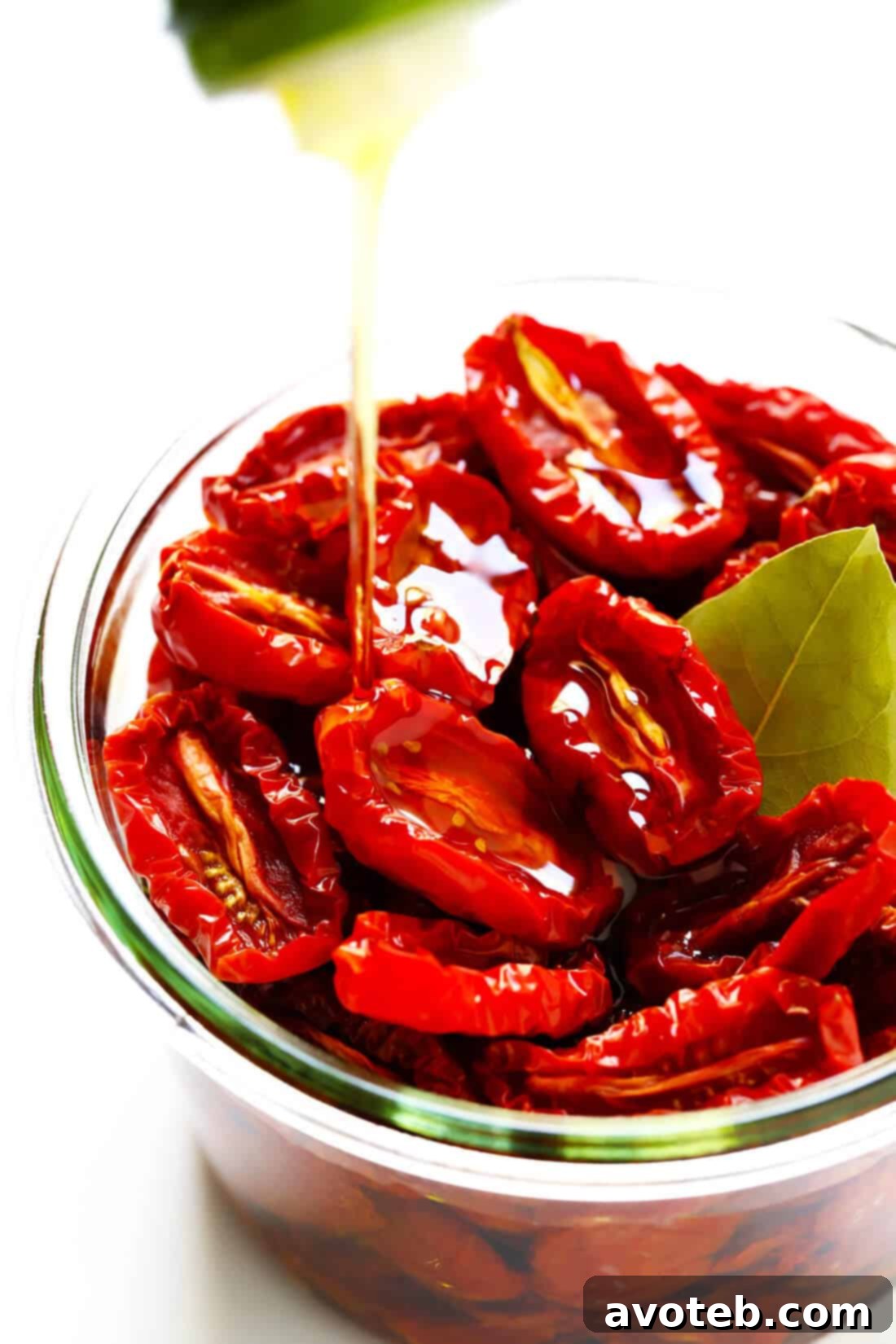 Learn how to make sun-dried tomatoes in the oven! This recipe can be easily customized to be as spicy, garlicky, herby or plain as you prefer. | gimmesomeoven.com #sundriedtomatoes #tomatoes #summer #topping #italian #healthy #vegan #glutenfree Homemade Sun-Dried Tomatoes: A close-up view of a pile of freshly oven-dried tomatoes, showcasing their rich color and texture.