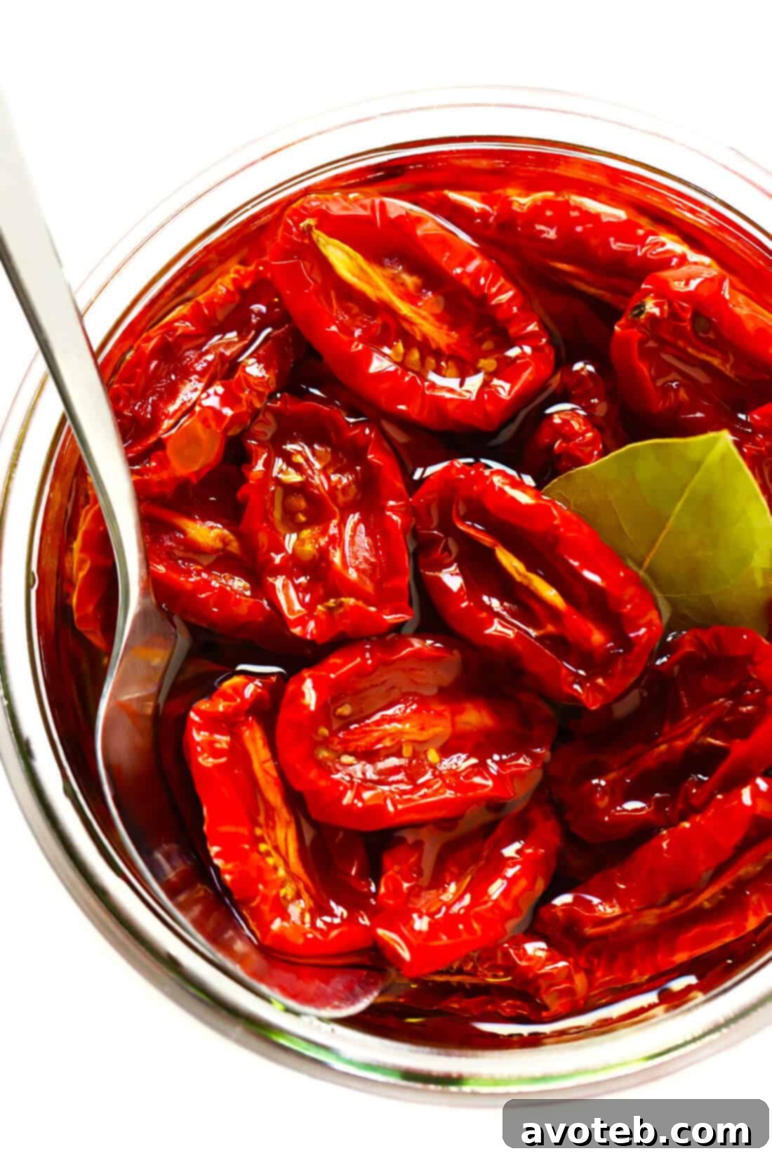 Learn how to make sun-dried tomatoes in the oven! This recipe can be easily customized to be as spicy, garlicky, herby or plain as you prefer. | gimmesomeoven.com #sundriedtomatoes #tomatoes #summer #topping #italian #healthy #vegan #glutenfree Homemade Sun-Dried Tomatoes in Olive Oil: Jars filled with vibrant sun-dried tomatoes submerged in golden olive oil with garlic and herbs.