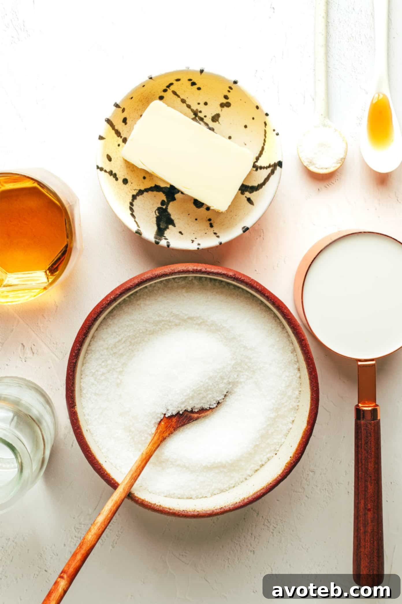 A close-up of ingredients for Bourbon Caramel Sauce laid out on a counter.