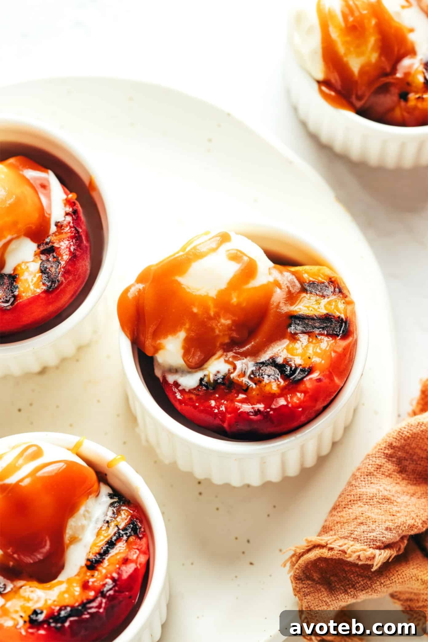 Grilled peaches with bourbon caramel sauce topped with vanilla ice cream