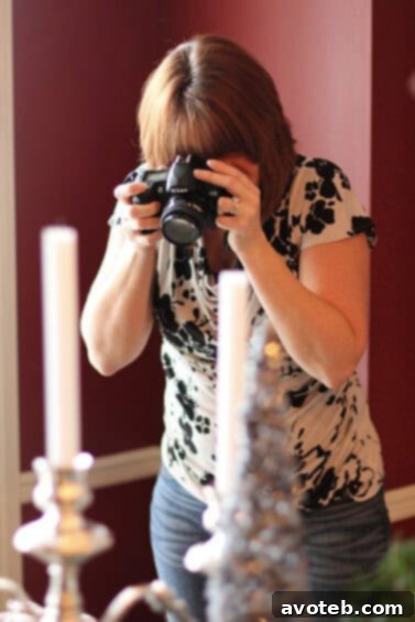 Sandie, a Kansas City food blogger, capturing the vibrant atmosphere and delicious spread with her camera at the cookie exchange.