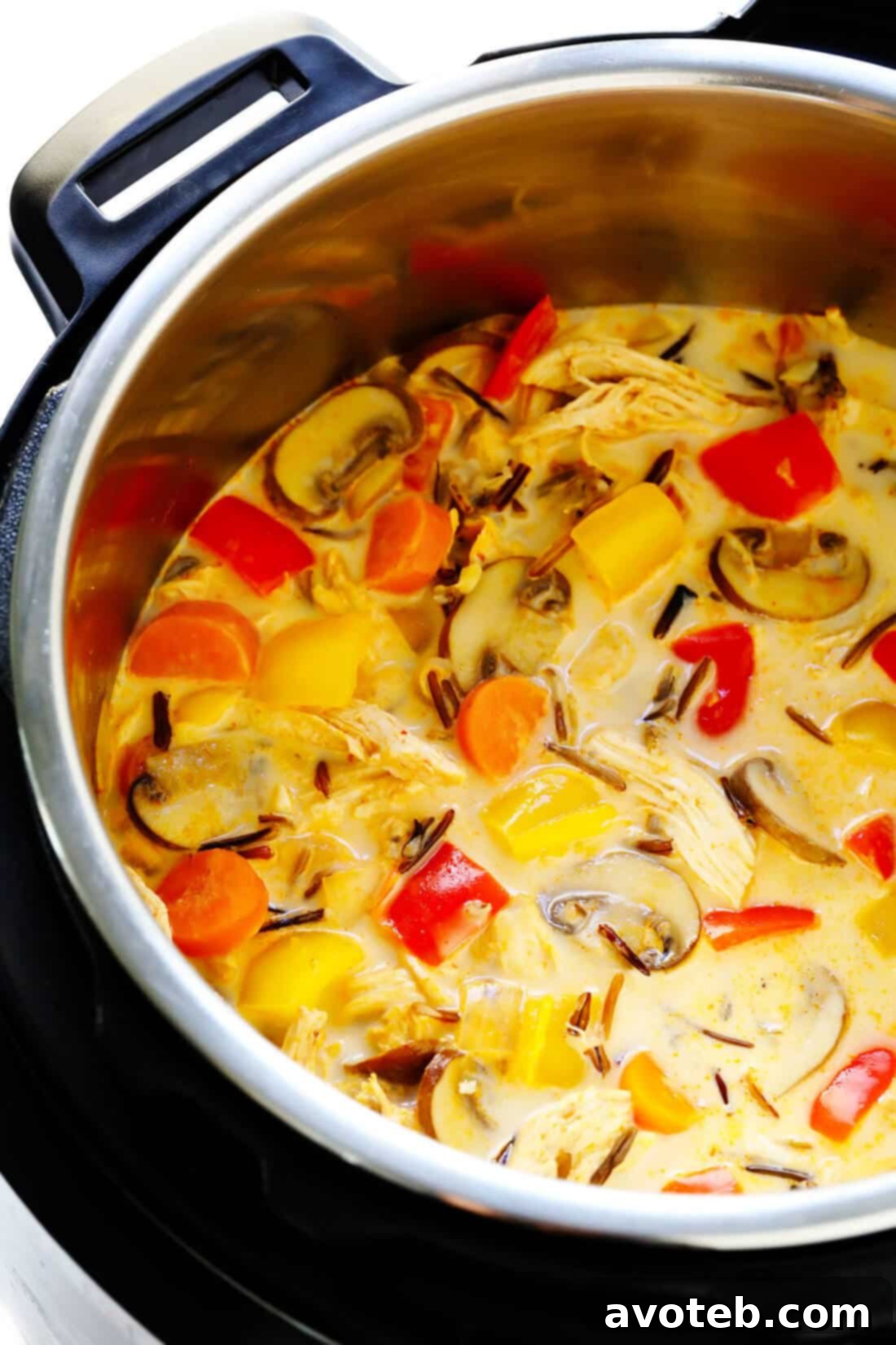 Thai Curry Chicken Soup: A hearty and healthy meal featuring tender chicken, wild rice, and a vibrant Thai red curry broth, garnished with fresh cilantro and lime.