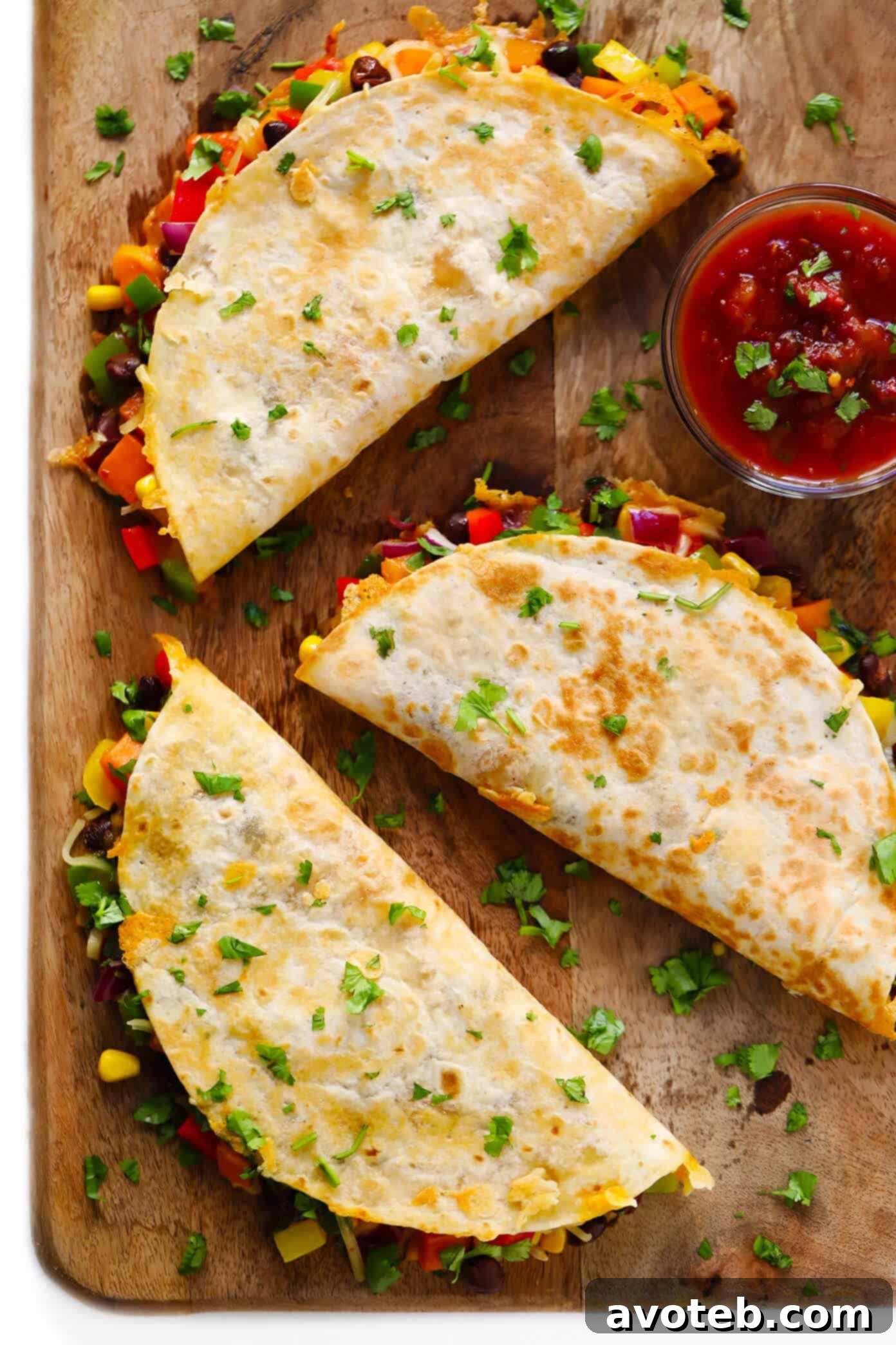 Customize your easy veggie quesadillas with any vegetables and cheese you prefer. Add extra protein like chicken or shrimp for a heartier meal, and use any kind of tortillas. | gimmesomeoven.com #quesadilla #vegetarian #veggie #dinner #healthy #mexican #mealprep #freezermeal Finished Easy Veggie Quesadillas, sliced into triangles and ready to serve