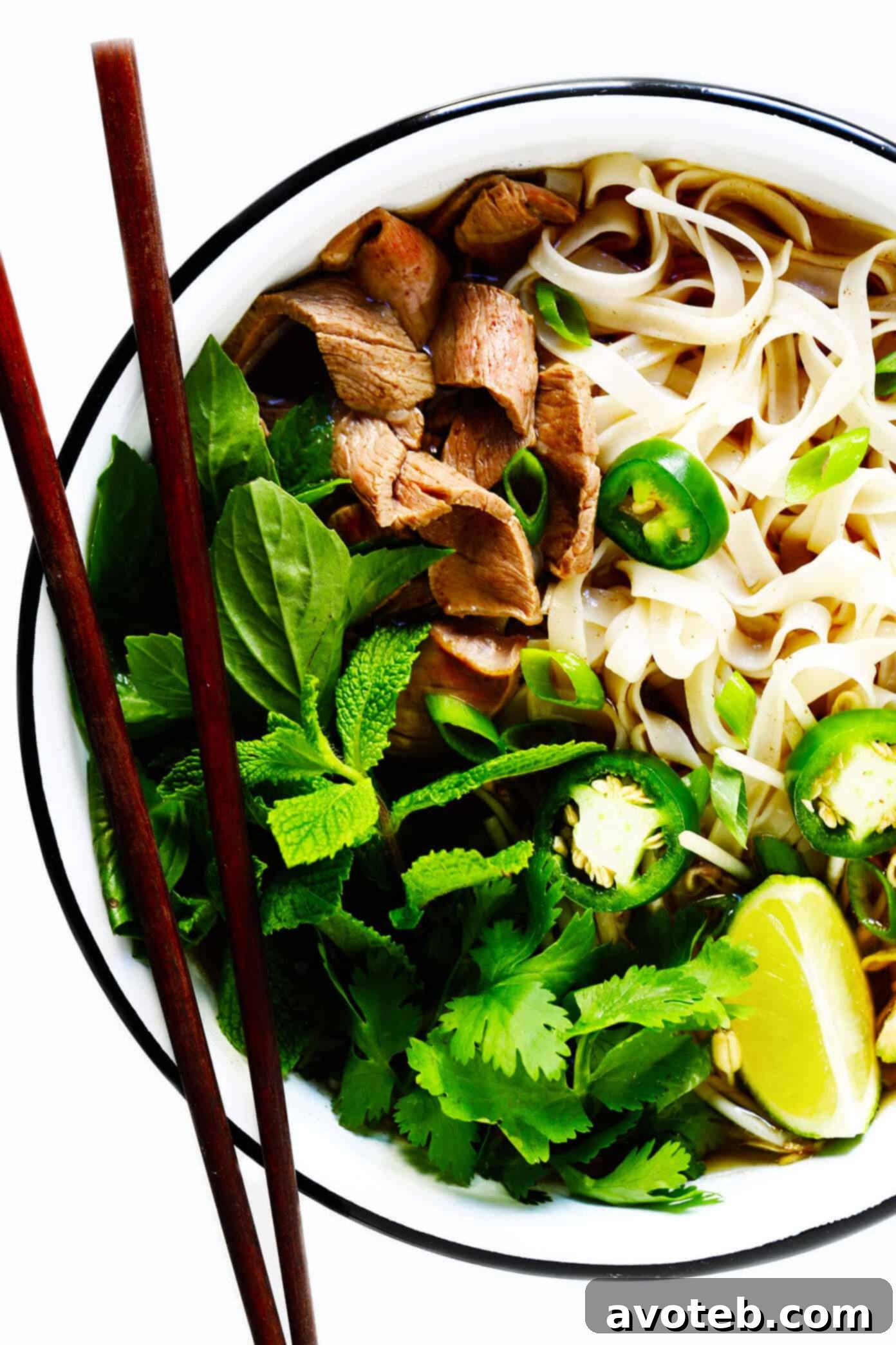 This homemade Vietnamese pho recipe features a robust and savory broth, delicate rice noodles, your choice of protein like beef, chicken, pork, or shrimp, and is generously finished with an array of fresh herbs and delicious toppings. A wonderful and naturally gluten-free dinner option. Customizable Pho Soup with Beef, Chicken, Pork or Shrimp