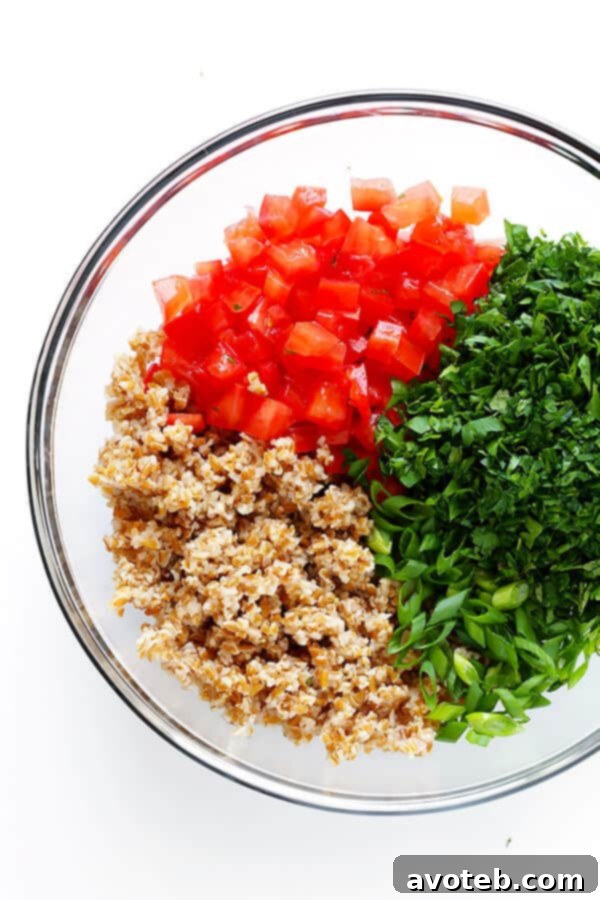 Close-up of fresh, finely chopped parsley and mint, essential ingredients for an authentic tabbouleh recipe.