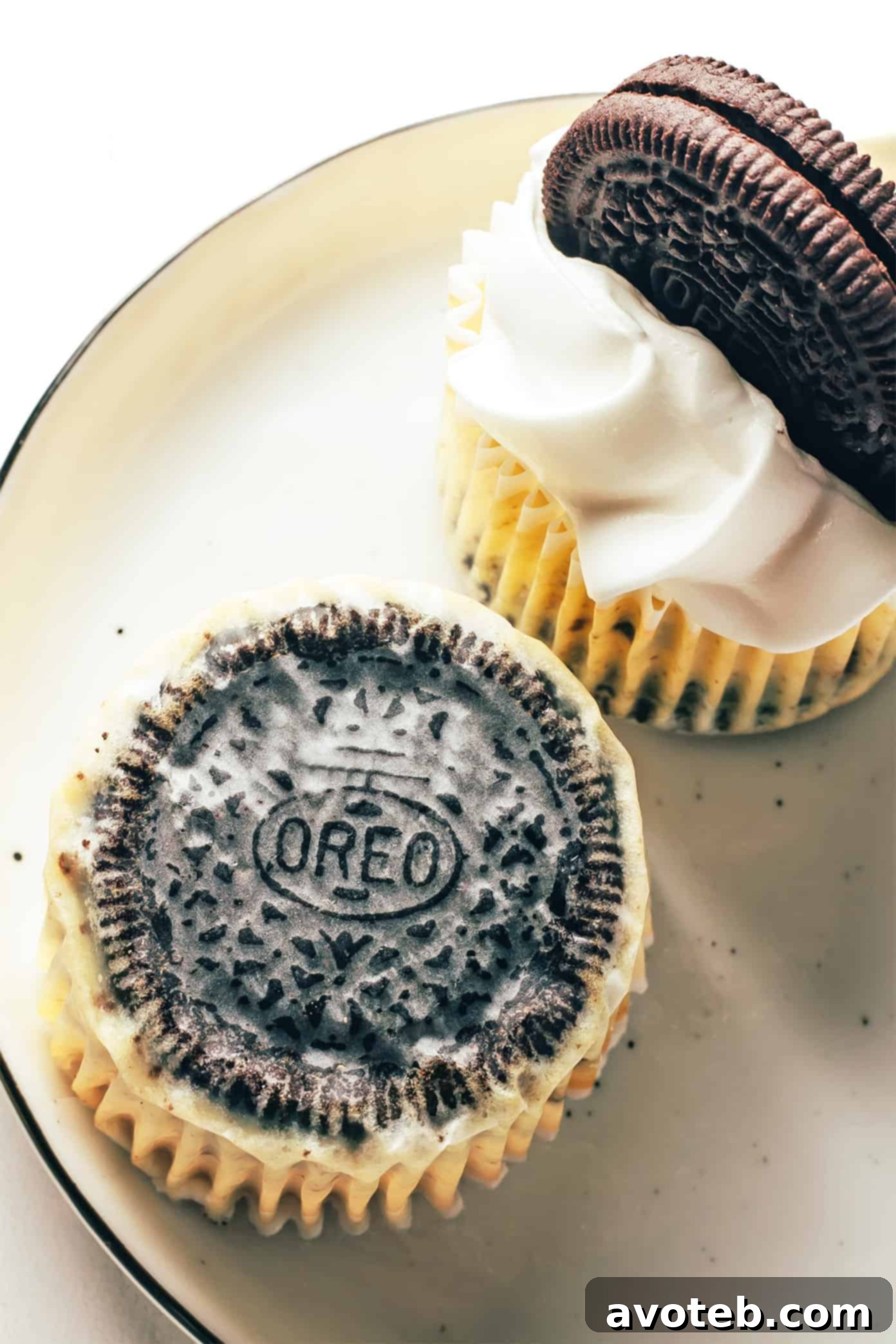Oreo cookie visible through the bottom of a cheesecake wrapper, indicating the crust