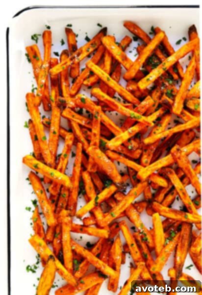 The BEST Crispy Baked Sweet Potato Fries Recipe - A recipe card image showing golden sweet potato fries.