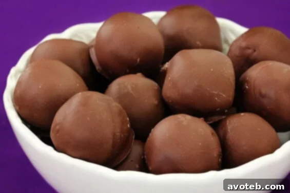 Irresistible Chocolate Chip Cookie Dough Truffles Delicious Chocolate Chip Cookie Dough Truffles arranged on a white plate, ready to be enjoyed.