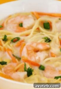 Coconut Shrimp Soup with lime and cilantro garnish
