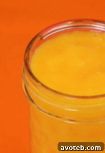 Orange Smoothie garnished with orange slices and mint.