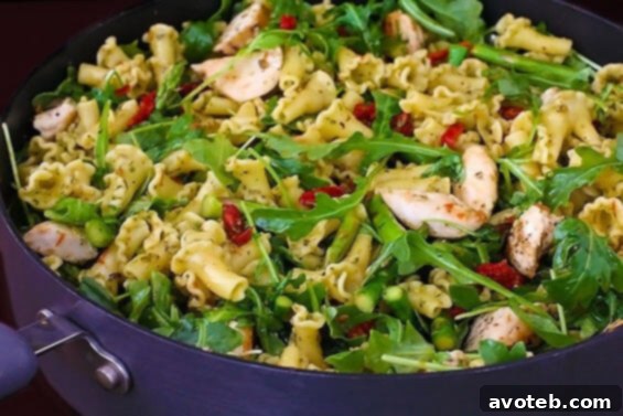 Pesto Pasta With Chicken, Asparagus & Arugula | gimmesomeoven.com Close-up of Pesto Pasta with Chicken, Asparagus, and Arugula, showcasing the vibrant colors.