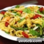 Pesto Pasta with Chicken, Asparagus & Arugula, ready to be served.