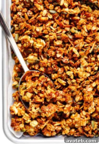 Golden Tahini Granola 2 Tahini Granola - A close-up of crispy, golden-brown granola with clusters, featuring nuts and sesame seeds.