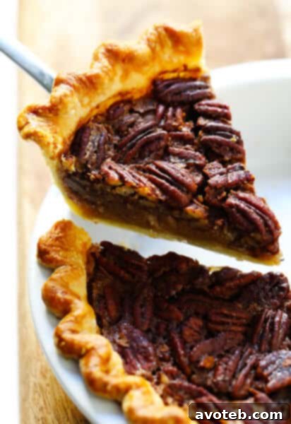 Wholesome Pecan Pie No Corn Syrup 2 A slice of delicious pecan pie with whole pecans on top.