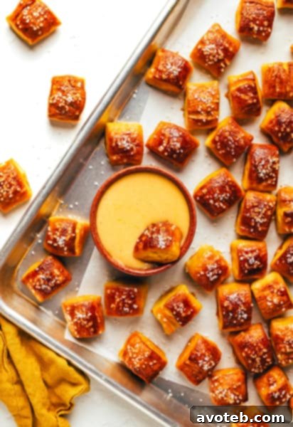 Delicious Buttery Soft Pretzel Bites served with a side of cheese dip, ready for snacking.
