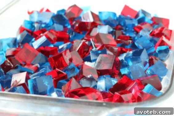 Stained Glass Jello squares, showcasing the layered red, white, and blue colors, ready for serving.