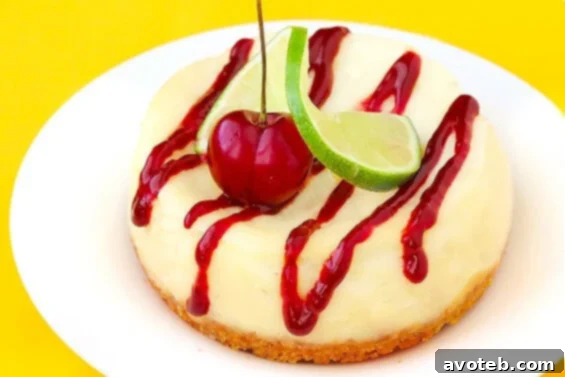 Cherry Limeade Cheesecake, garnished with fresh lime slices and cherries.
