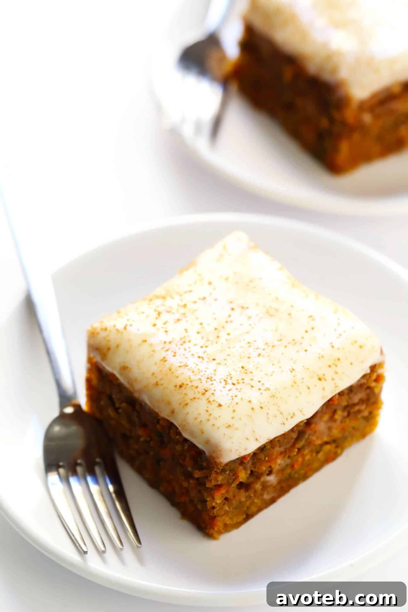 This amazing Carrot Cake Bars recipe is easy to make, perfectly moist and lightly spiced and full of fresh carrots, and topped with the most heavenly cream cheese frosting. Perfect for Easter, spring time, or whenever you happen to be craving this classic dessert! | gimmesomeoven.com #carrot #cake #bars #dessert #creamcheese #frosting #icing #easter #spring #vegetarian #holiday Carrot Cake Bars with Cream Cheese Frosting Recipe